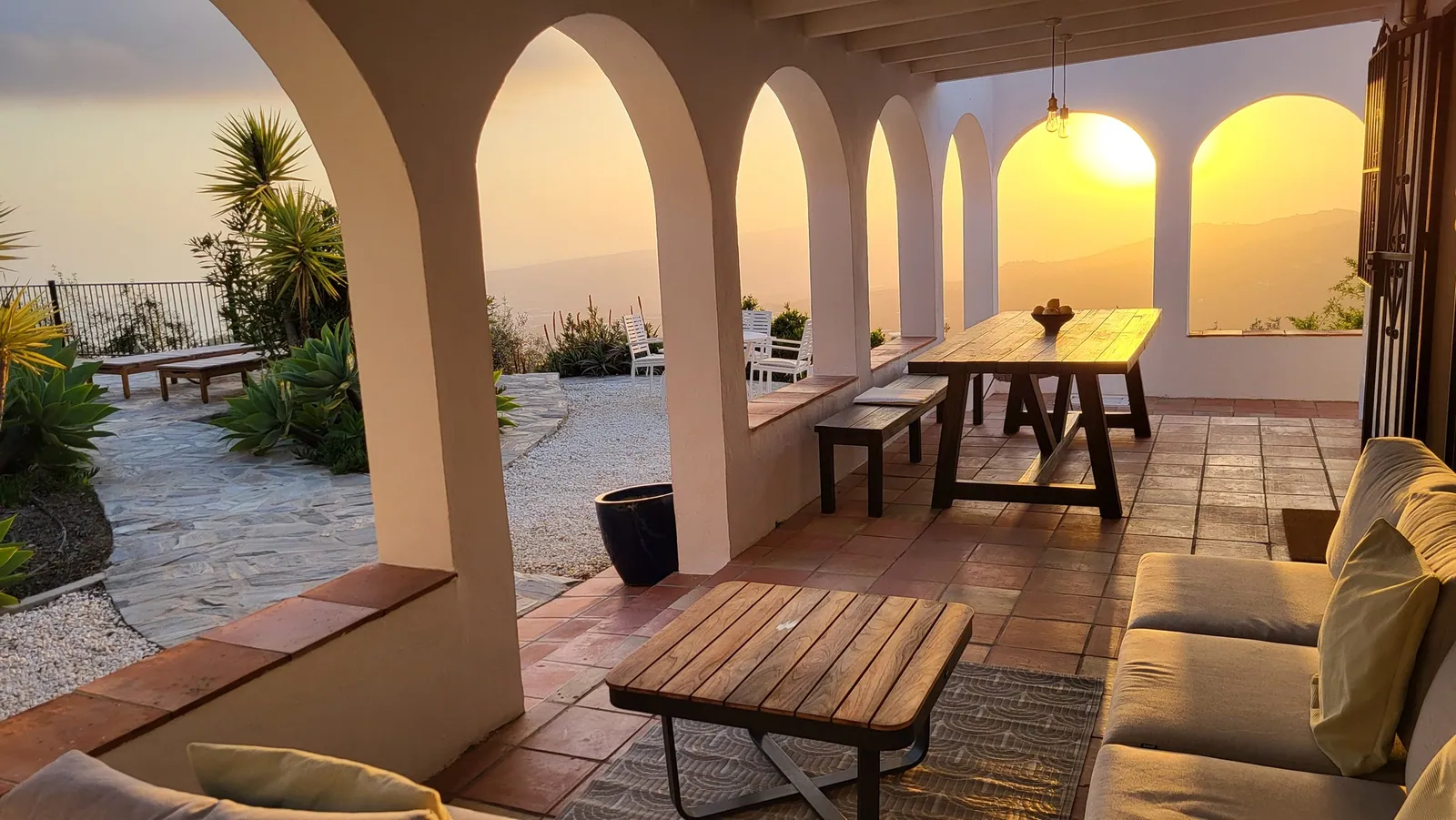 Outdoor dining beneath the arches at sunset