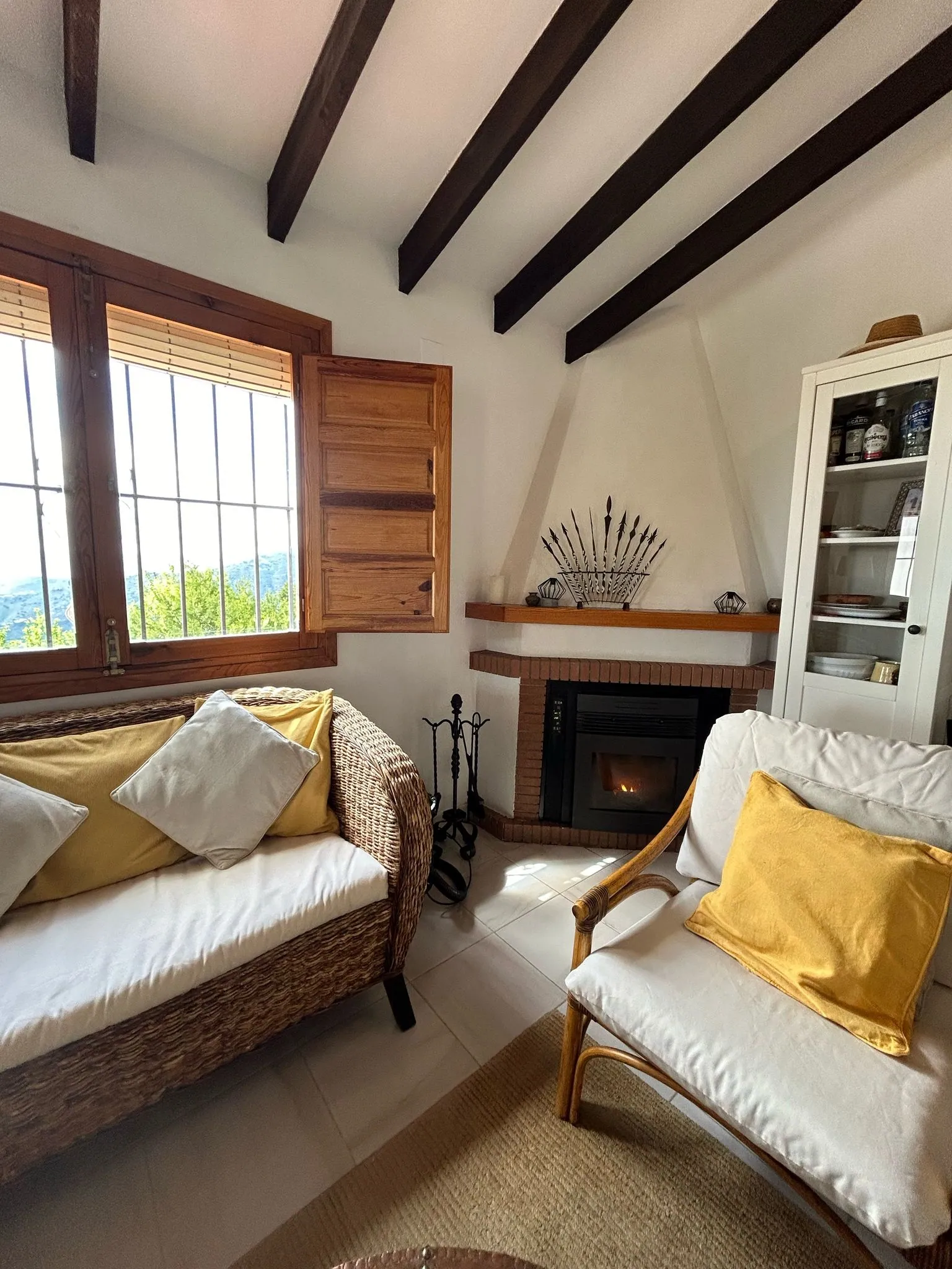Living room with a fireplace and wooden shutters