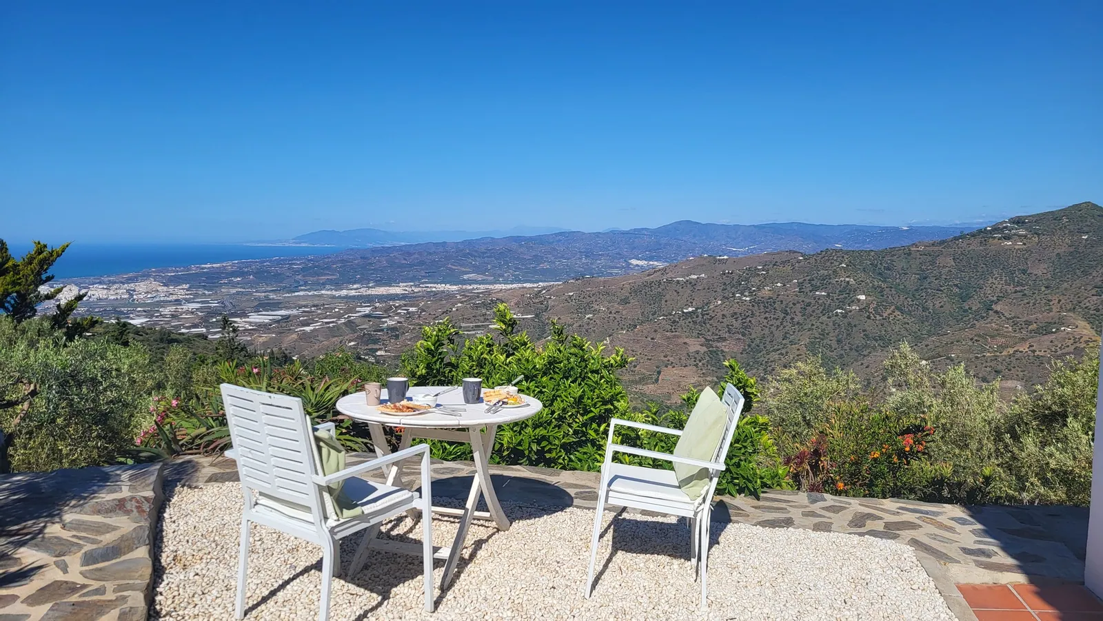 Breakfast table with views across the valley to the sea