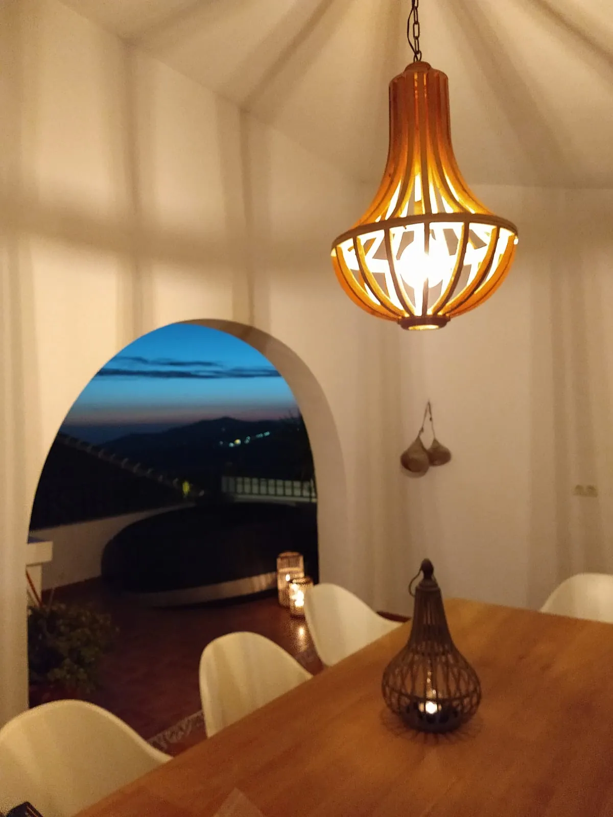 Dining table beside the terrace at dusk